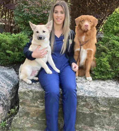 Ashley sitting with her two dogs